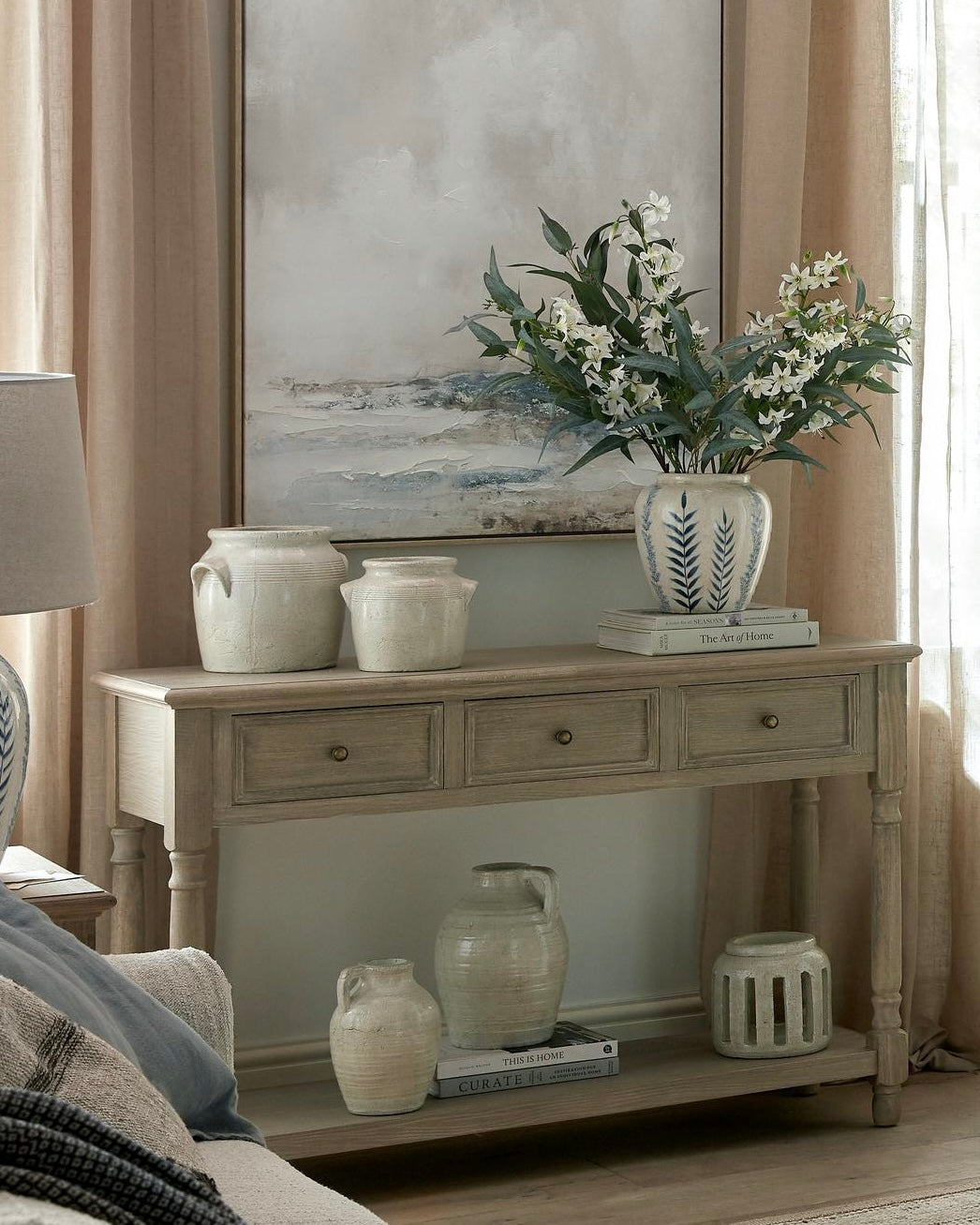 Hill Interiors Delphine Collection 3-drawer console with shelf, showcasing sleek wooden furniture with modern design and storage space.