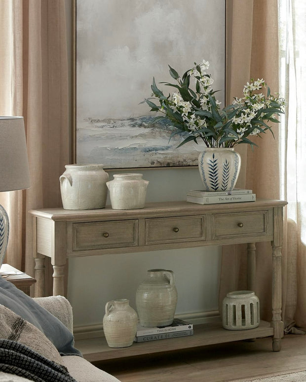 Delphine Collection 3-drawer console with shelf by Hill Interiors, showcasing a stylish wooden furniture piece with drawers and open shelving.