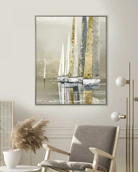 Abstract painting of sailboats on a wall above a chair in a room.