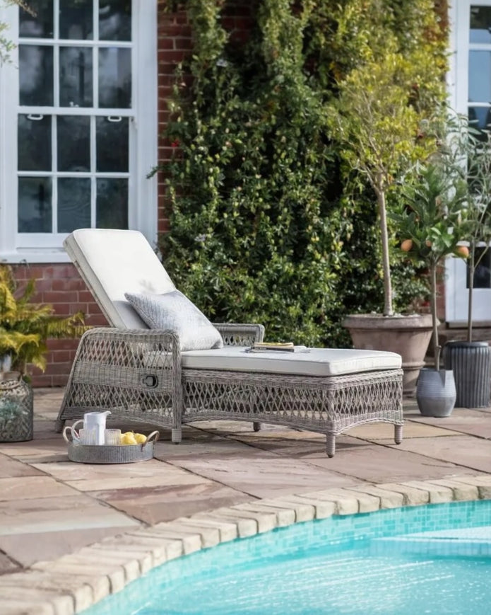 Natural rattan Menton outdoor lounger from Gallery Direct, featuring a comfortable garden furniture design for outdoor relaxation.