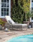 Natural rattan Menton outdoor lounger from Gallery Direct, featuring a comfortable garden furniture design for outdoor relaxation.