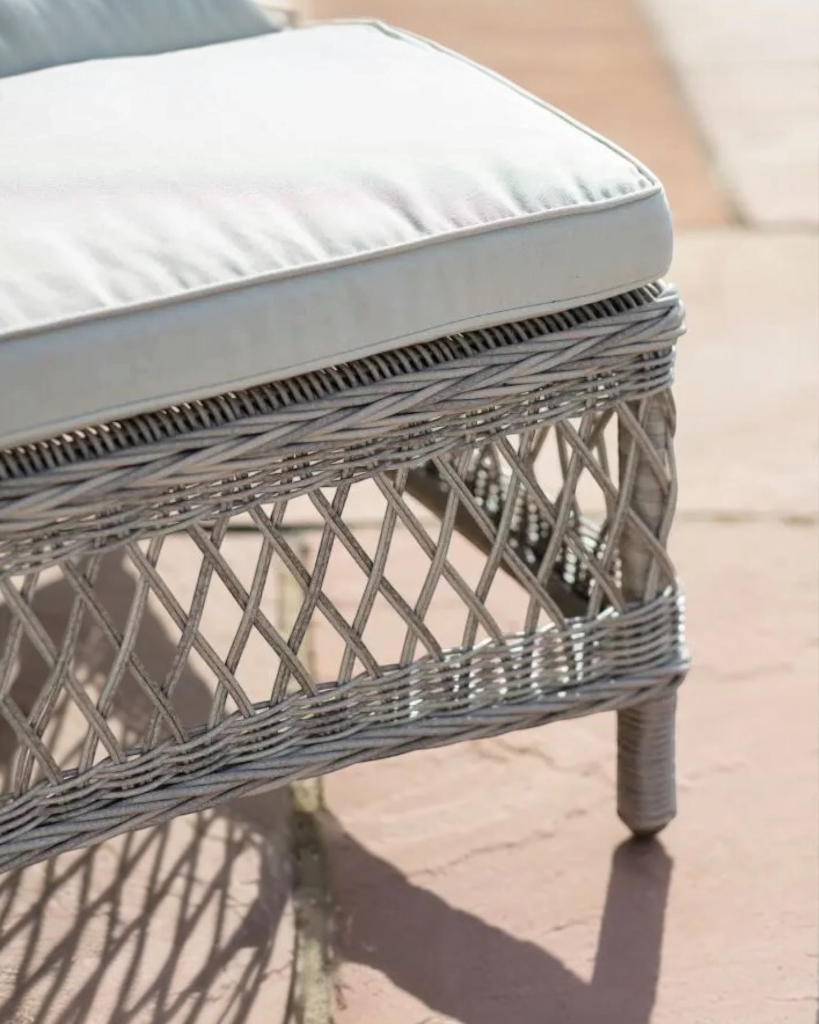Natural rattan Menton outdoor lounger from Gallery Direct, garden furniture with cushioned seating and stylish design.
