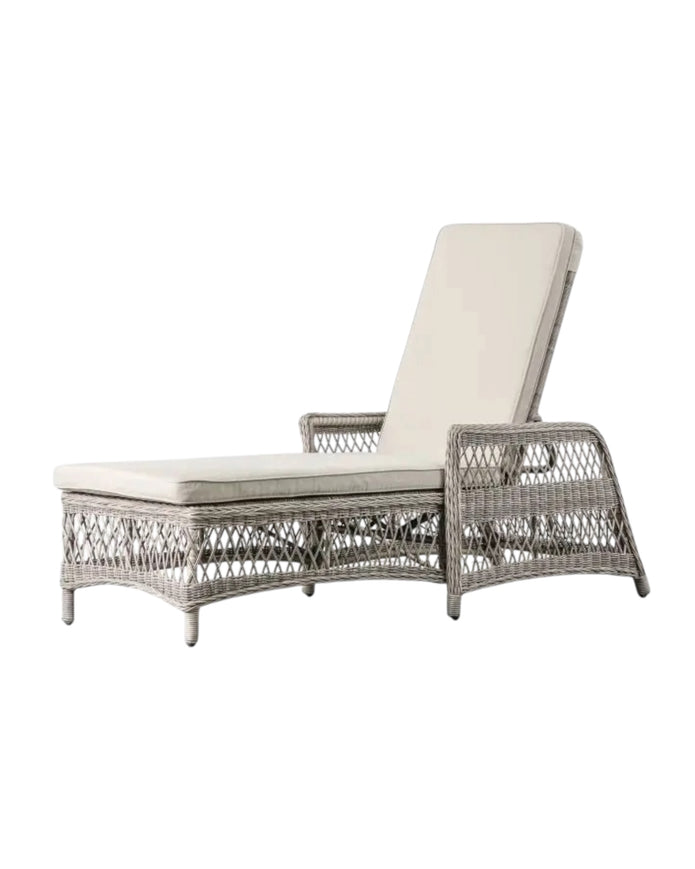 Natural rattan Menton outdoor lounger by Gallery Direct for garden relaxation, shown with cushioned seat and sturdy frame.