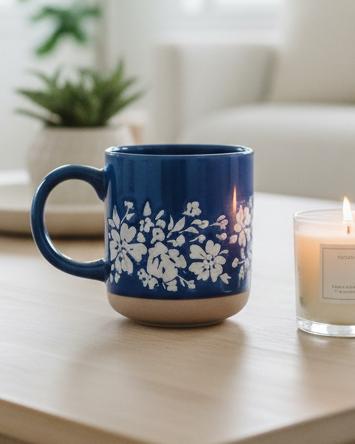 Blue floral stoneware coffee mug by Sweet Water Decor with a charming blue and white floral pattern.