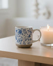 Blue Delft stoneware coffee mug by Sweet Water Decor with intricate blue and white floral patterns on a ceramic mug.
