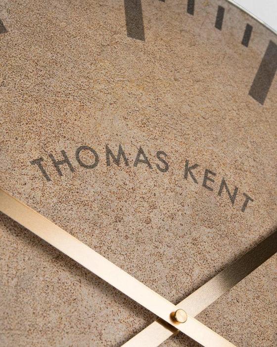 Close-up of a clock face with 'Thomas Kent' branding.