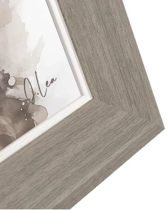 Close-up of a wooden picture frame with a blurred artwork inside