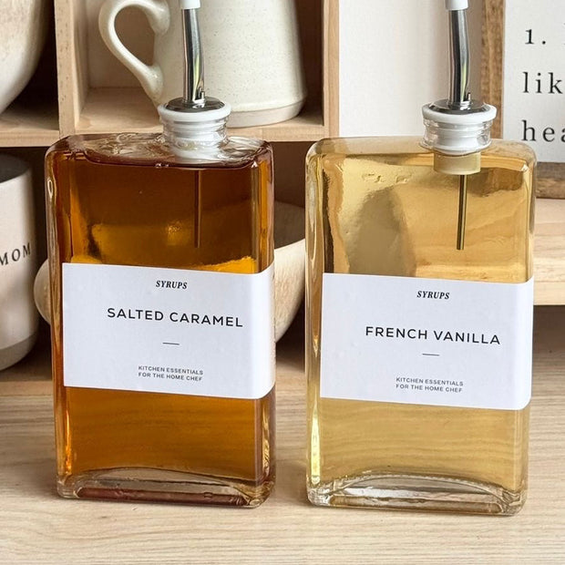Gold glass dispenser bottles with pourer and label set for kitchen and dining, featuring elegant design by Starlight Express.