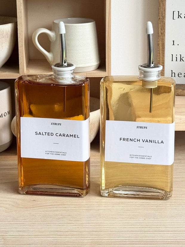 Gold glass dispenser bottles with pourer and label set for kitchen and dining, featuring elegant design by Starlight Express.