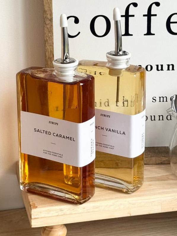 Gold glass dispenser bottles with pourers and labels, ideal for kitchen and dining storage by Starlight Express.