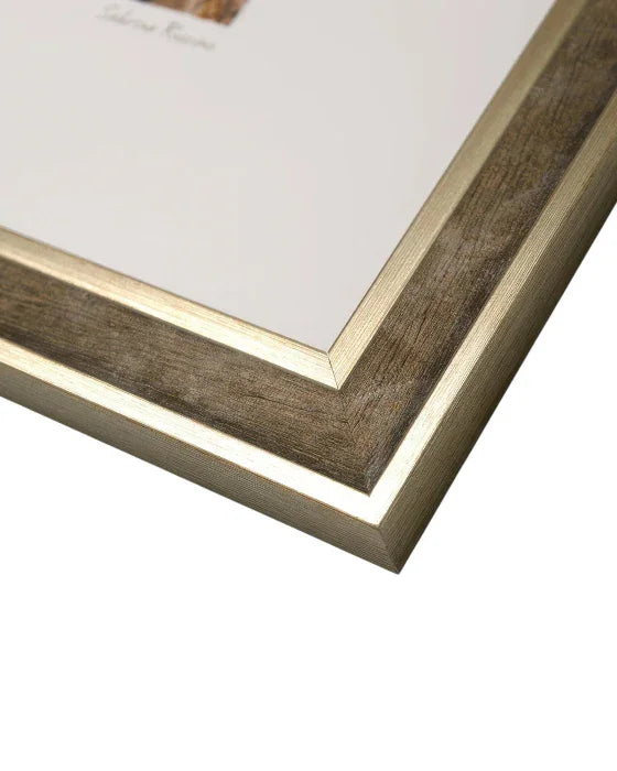 Close-up of a wooden picture frame with gold trim on a white background