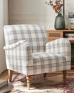 Starlight Express neutral checked arm chair with wooden legs, showcasing a cozy, modern furniture piece ideal for living rooms.