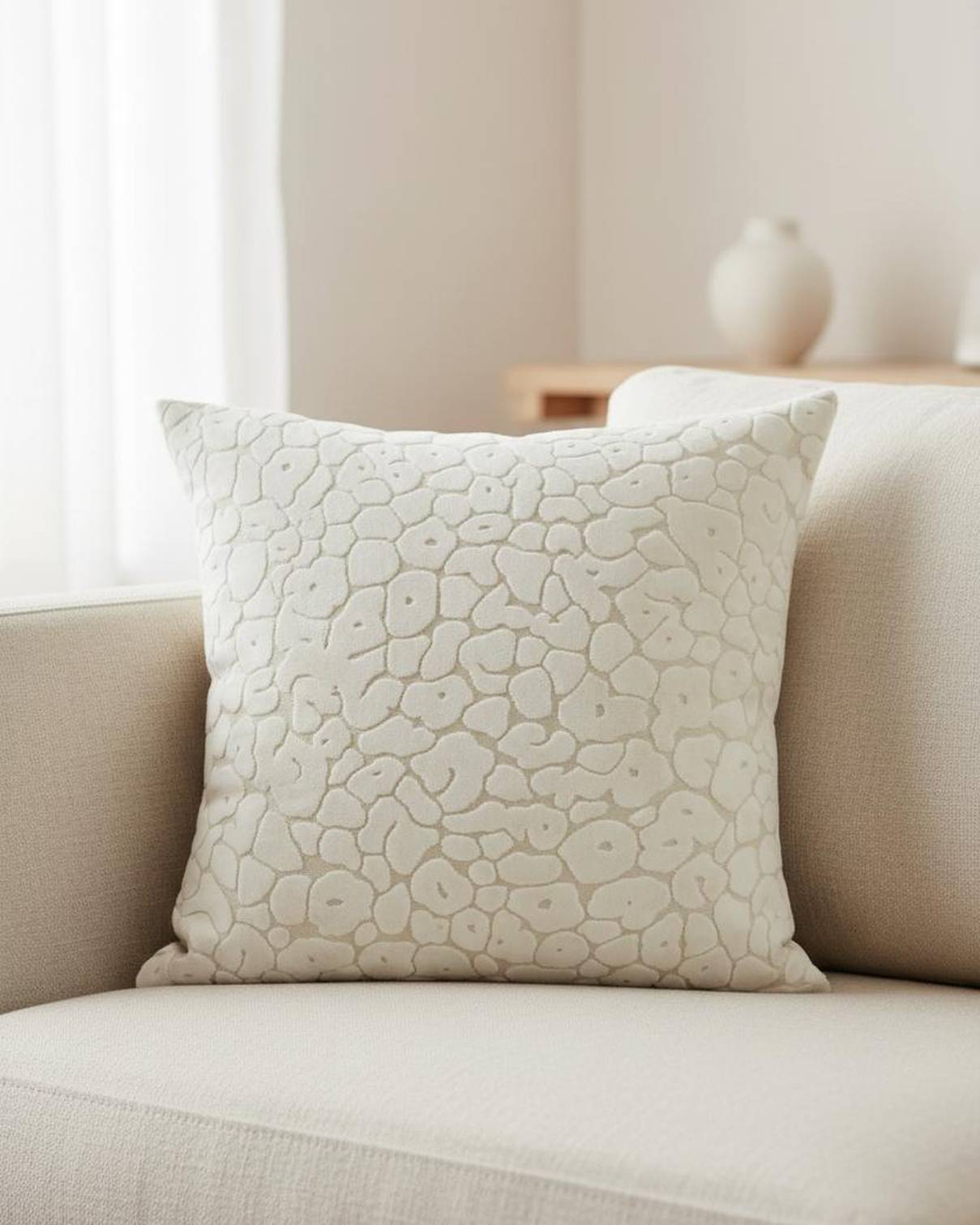 Neutral cream velvet cushion cover with leopard print pattern by Malini, featuring soft, luxurious fabric and stylish design.