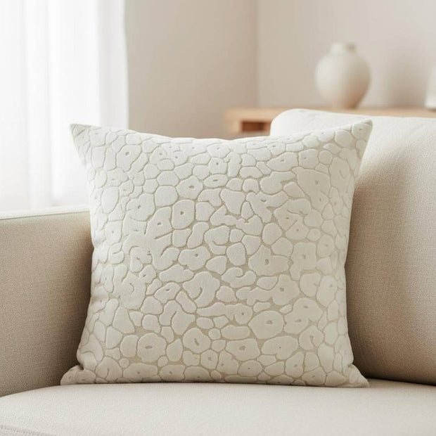 Neutral cream velvet cushion cover with leopard print pattern by Malini, featuring soft, luxurious fabric and stylish design.