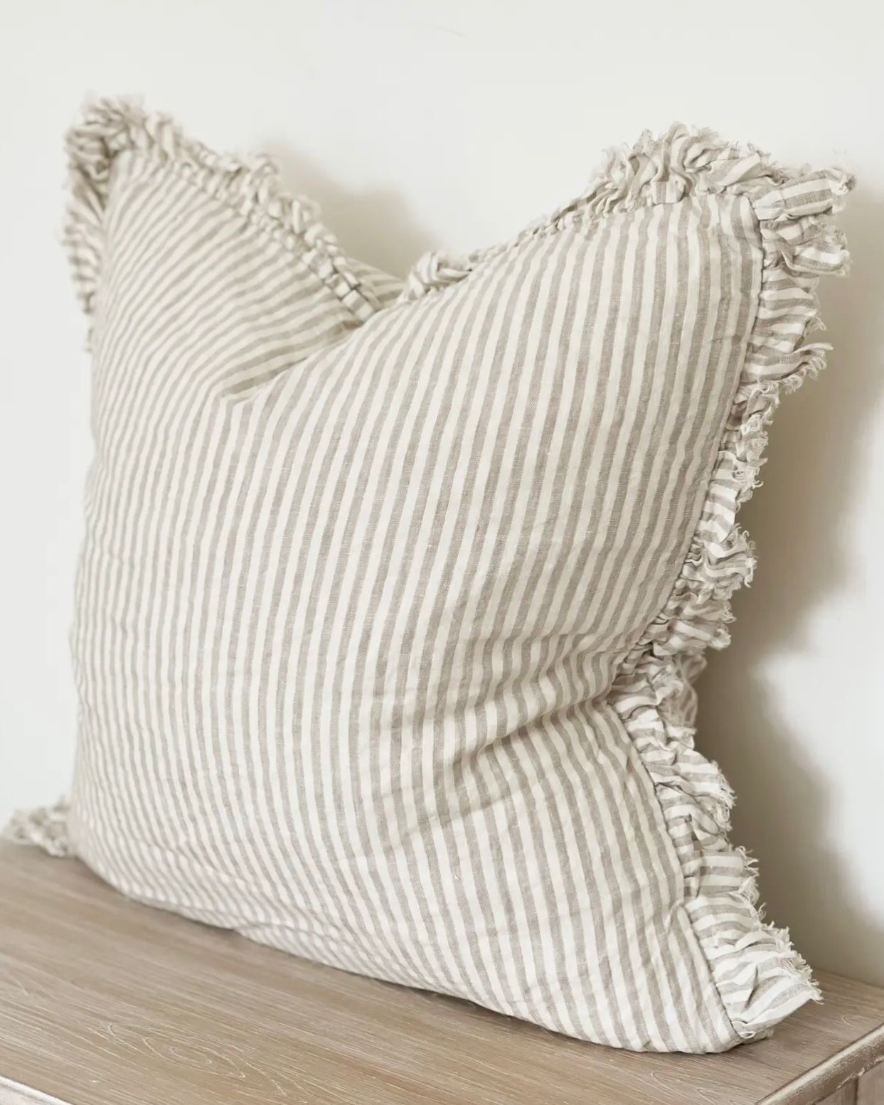Beige square cushion cover with subtle pinstripe pattern from Ellenvale Trade, made of soft, durable fabric for stylish home decor.