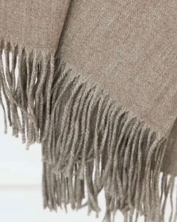 Beige and brown fine knit tasseled throw blanket from Ellenvale Trade, soft and cozy home furnishing accessory.
