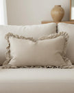 Beige luxury linen cushion cover with ruffled edges, soft furnishings by Ellenvale Trade, showcasing elegant textured fabric.