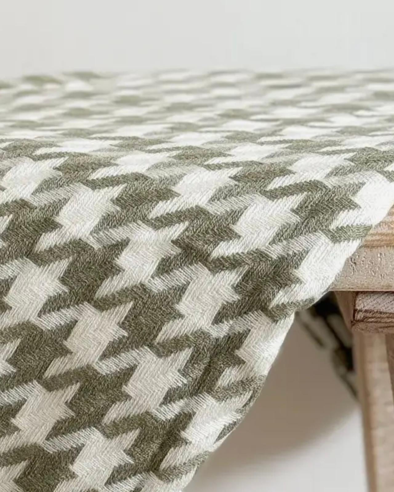Olive green houndstooth blanket throw from Ellenvale Trade, soft furnishings with a cozy, stylish pattern.