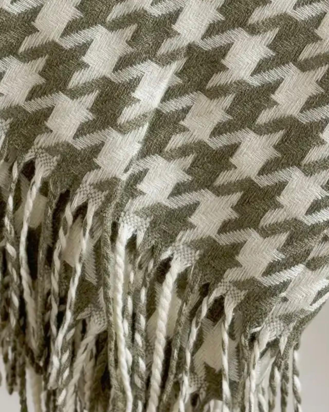 Olive green houndstooth blanket throw from Ellenvale Trade, soft and cozy for home decor or lounging.
