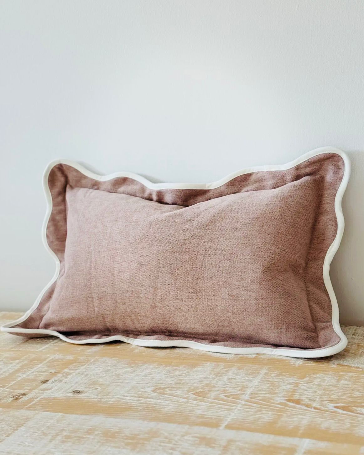 Dusty pink rectangle cushion cover with scalloped edges, made of soft furnishings material by Ellenvale Trade.