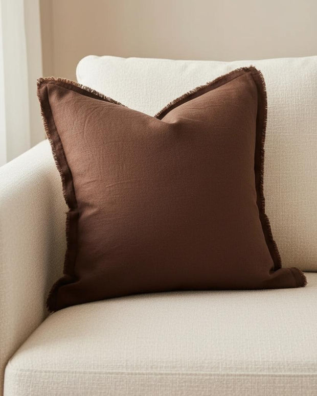 Dark brown linen blend cushion cover with ruffle square design, soft furnishings by Ellenvale Trade, shown on a cozy sofa.