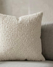 Cream boucle cushion cover from Starlight Express, soft furnishings with textured fabric and cozy appearance.