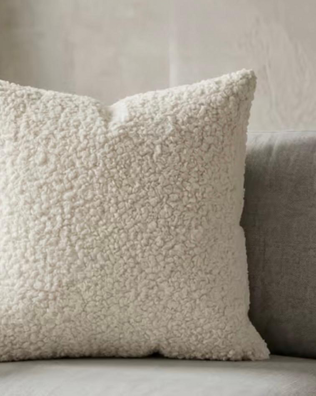 Cream boucle cushion cover from Starlight Express, soft furnishings with textured fabric and cozy appearance.