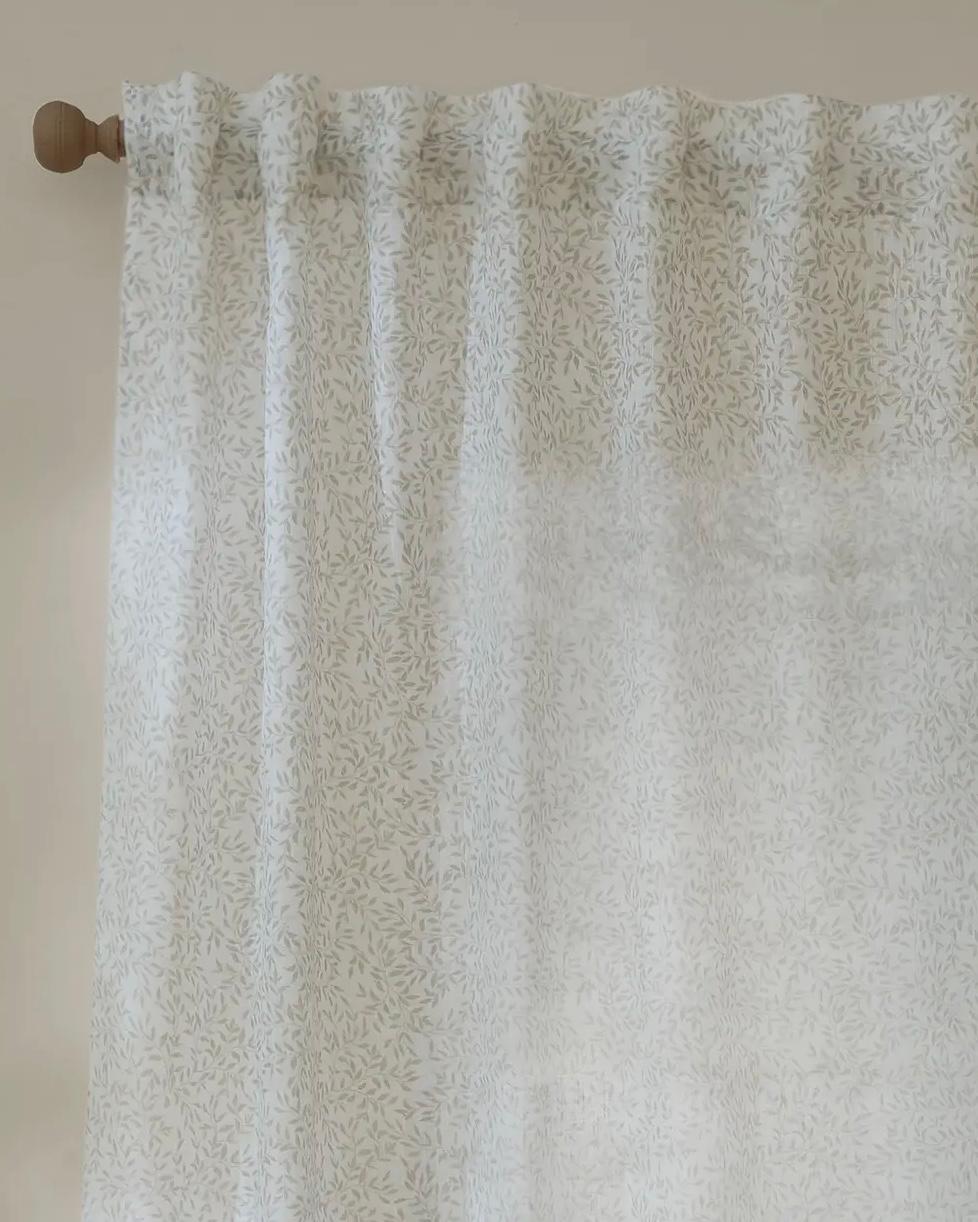 Natural woven voile curtain panel with yard leaf pattern, soft sheer fabric from Riva Home, ideal for light and airy window decor.