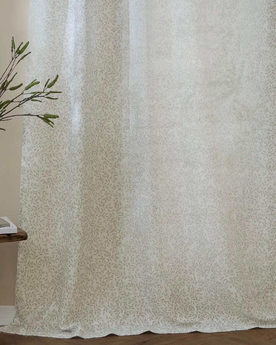 Riva Home yard leaf patterned natural woven sheer voile curtain panel hanging with sunlight filtering through.