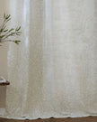 Riva Home yard leaf patterned natural woven sheer voile curtain panel hanging with sunlight filtering through.