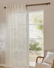 White woven sheer voile curtain panel by Riva Home, soft furnishings, draped fabric with a light, airy appearance.