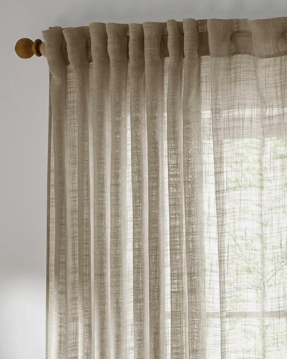 Riva Home yard natural woven sheer voile curtain panel hanging with soft flowing fabric for light filtering and privacy.