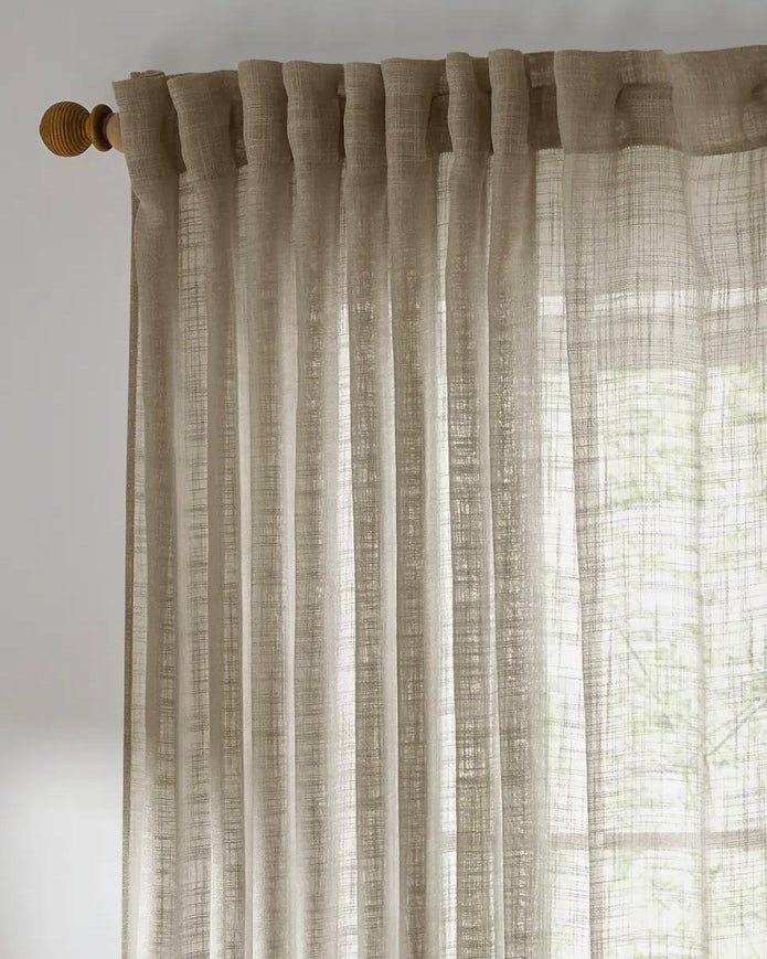 Riva Home yard natural woven sheer voile curtain panel hanging with soft flowing fabric for light filtering and privacy.
