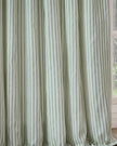 Sage green and black striped blackout eyelet curtains from Riva Home, soft furnishings with a stylish striped pattern and eyelet top.