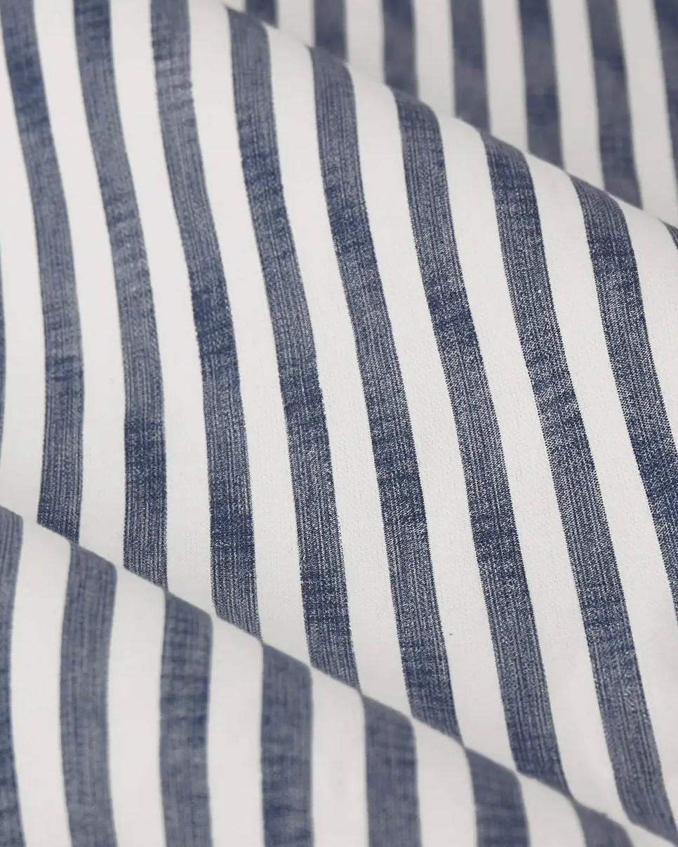 Navy blue striped blackout eyelet curtains from Riva Home, soft furnishings with black and navy pattern and eyelet top design.