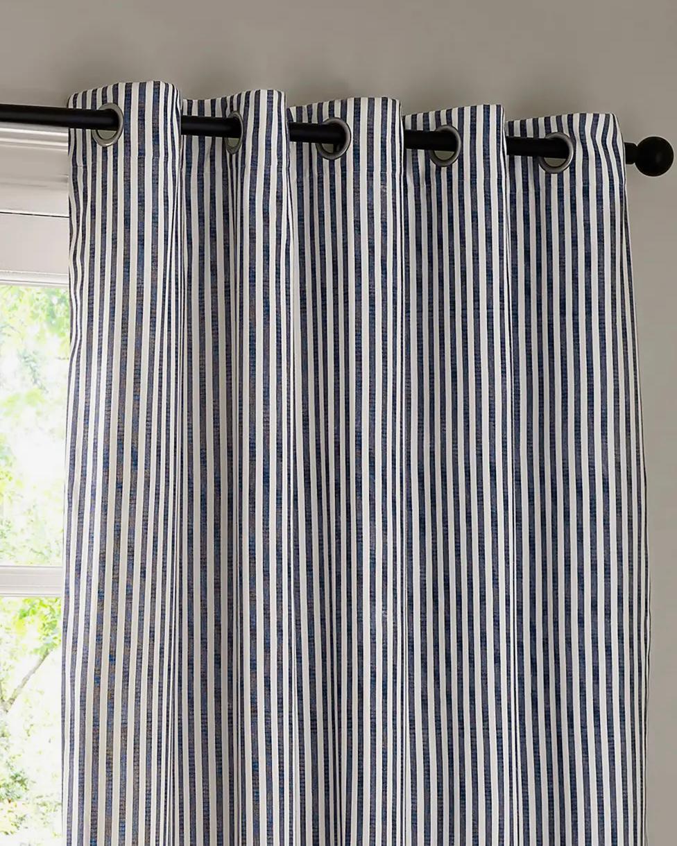 Navy blue and black striped blackout eyelet curtains from Riva Home, soft furnishings with metal eyelets and a stylish striped pattern.