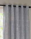 Navy blue and black striped blackout eyelet curtains from Riva Home, soft furnishings with metal eyelets and a stylish striped pattern.