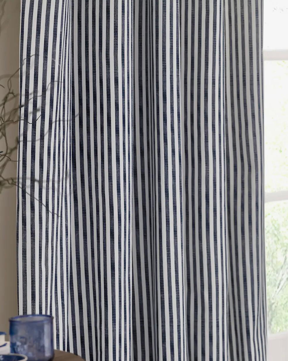 Navy blue and black striped blackout eyelet curtains from Riva Home, soft furnishings with a modern striped design and eyelet top.