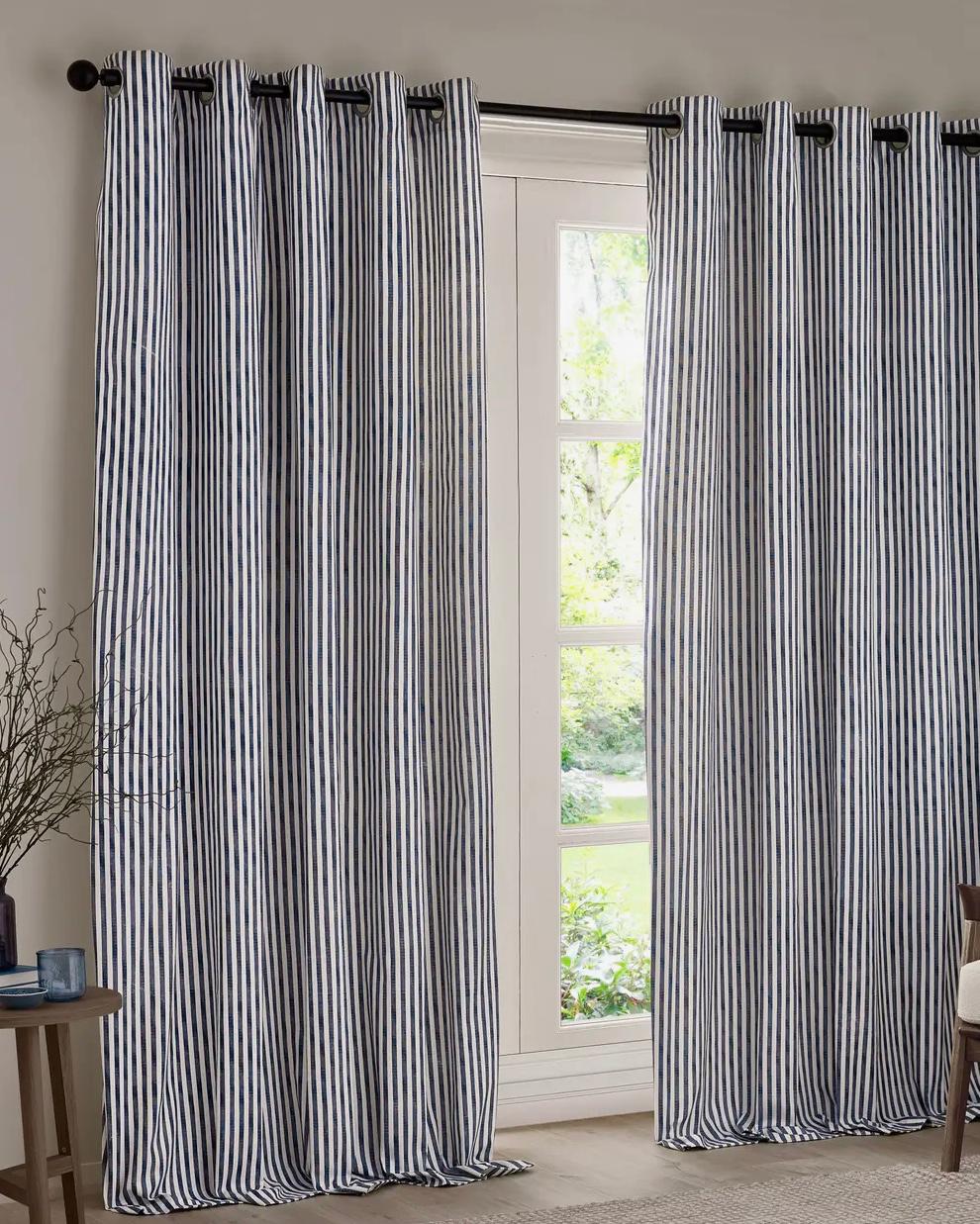 Navy blue and black striped blackout eyelet curtains from Riva Home, soft furnishings with stylish eyelet top design.