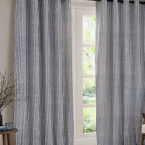 Navy blue and black striped blackout eyelet curtains from Riva Home, soft furnishings with stylish eyelet top design.