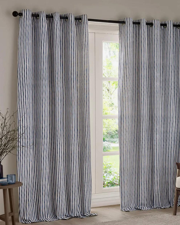 Navy blue and black striped blackout eyelet curtains from Riva Home, soft furnishings with stylish eyelet top design.