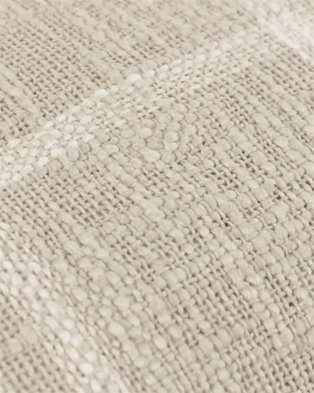 Riva Home Beni Natural cushion cover with textured fabric and neutral tones, showcasing its stylish and cozy design.