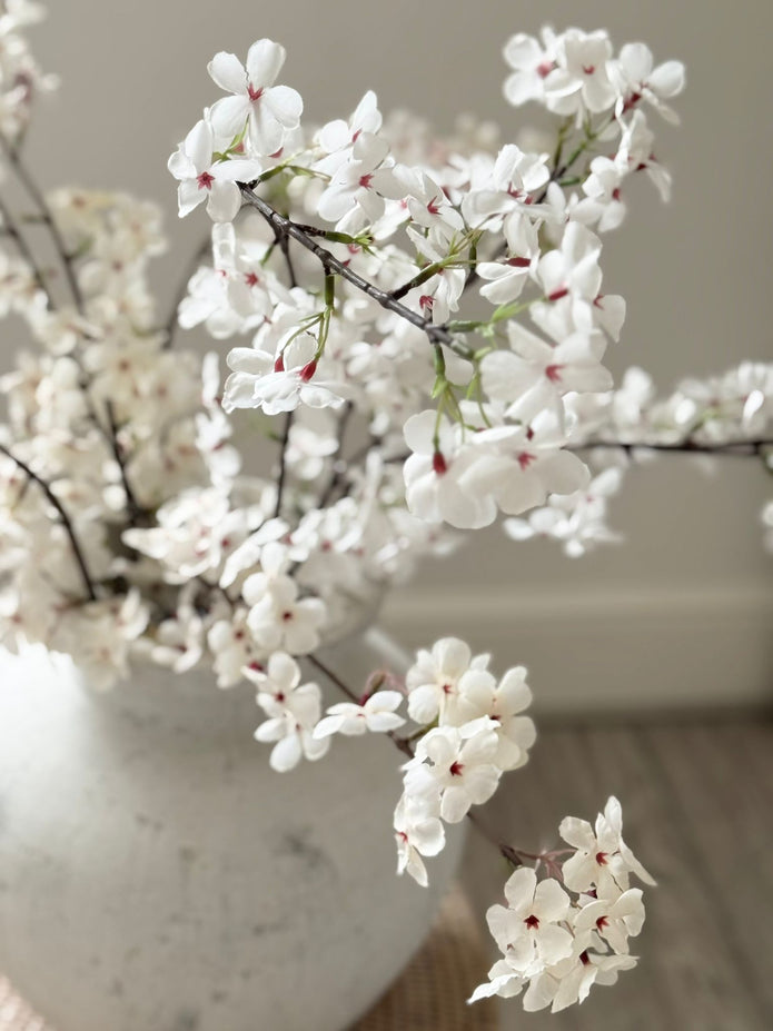 Artificial tall white cherry blossom stem from Starlight Express, showcasing delicate white blossoms on a slender stem.