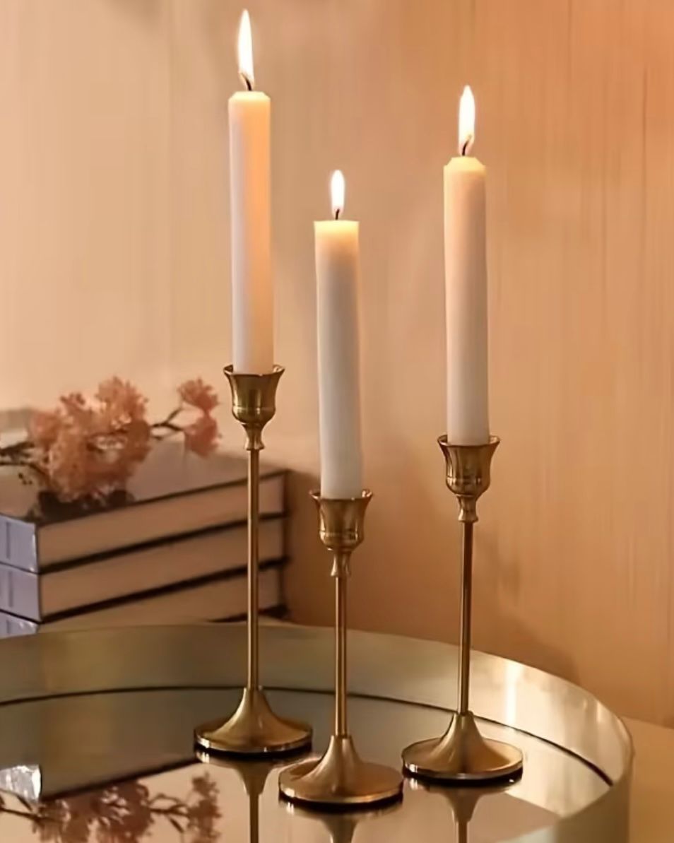 Antique brass effect taper candlestick for home decor, showcasing a vintage-style candle holder with a classic design.
