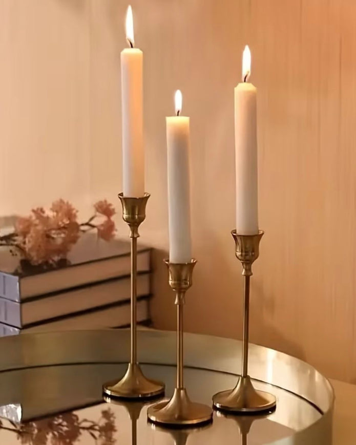 Antique brass effect taper candlestick for home decor, showcasing a vintage-style candle holder with a classic design.