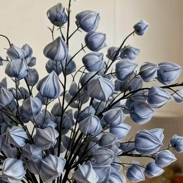 Artificial dusky blue lantern stem from Starlight Express, featuring realistic faux plant with vibrant blue lantern-shaped flowers.