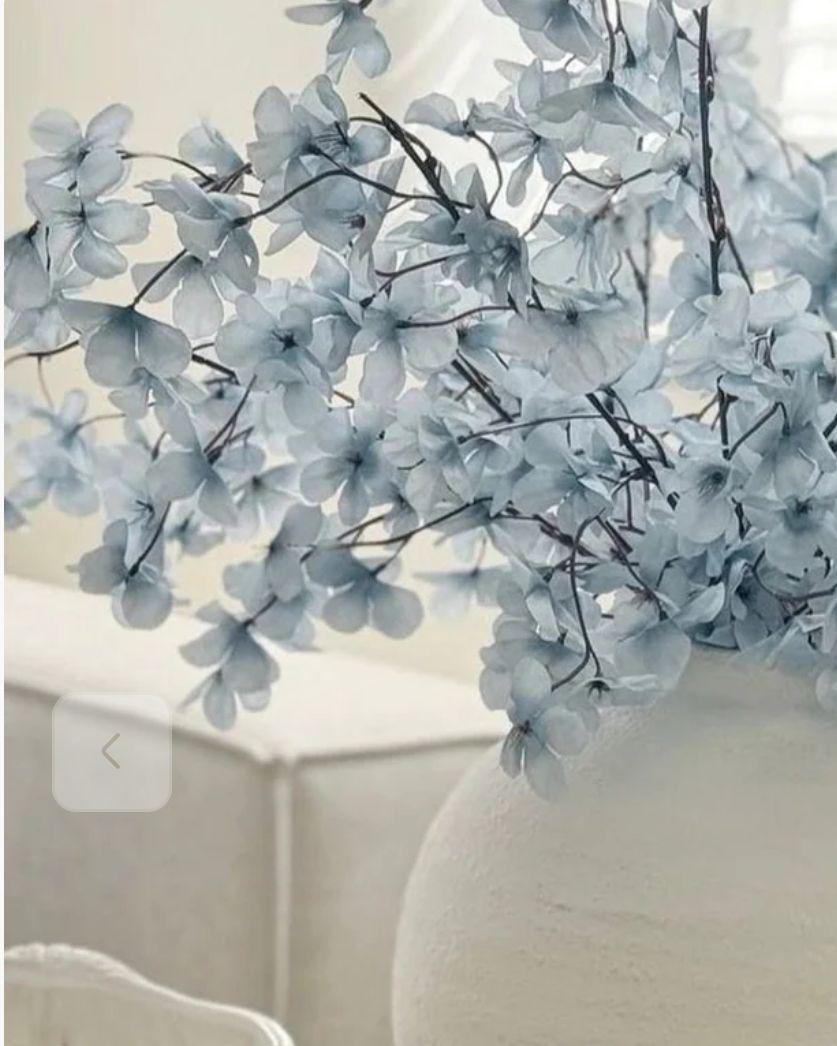 Artificial Ocean Blue Blossom Stem from Starlight Express, showcasing vibrant blue flowers and realistic green leaves.