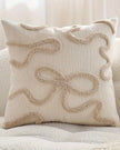 Cream and beige bow square boucle cushion cover from Starlight Express with soft, textured fabric and decorative bow detail.