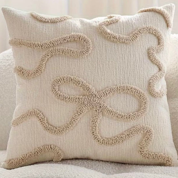 Cream and beige bow square boucle cushion cover from Starlight Express with soft, textured fabric and decorative bow detail.