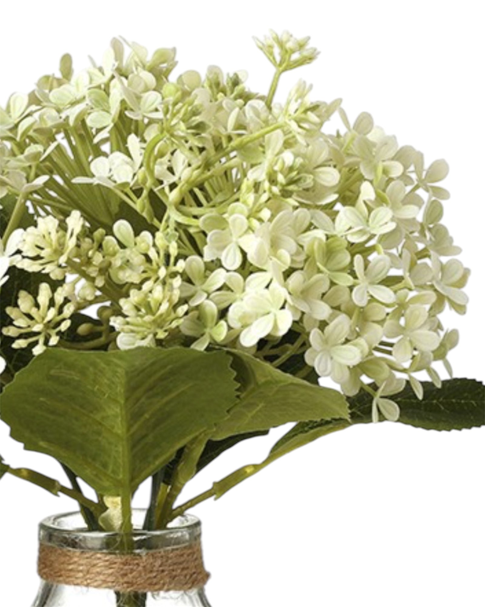 Artificial white flower arrangement in a glass vase by Heaven Sends, showcasing delicate blossoms and lush greenery.